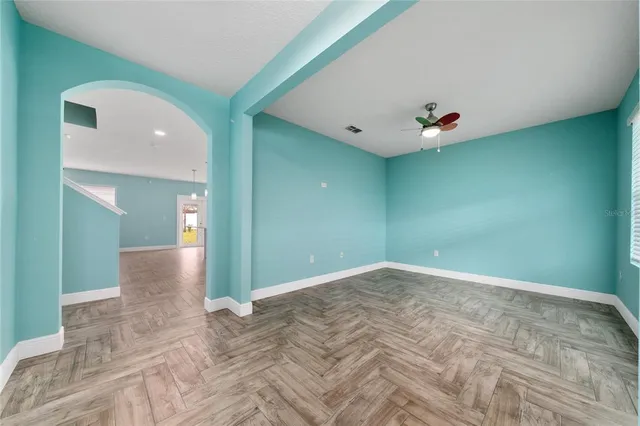 a view of a livingroom with wooden floor and a potted plant