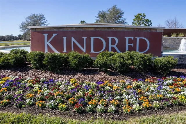 a sign that is sitting in front of flowers