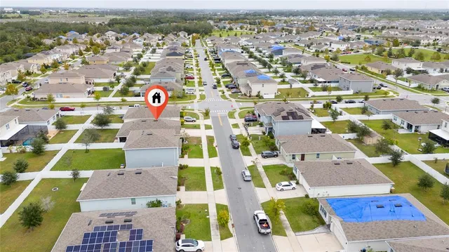 an aerial view of residential houses with outdoor space