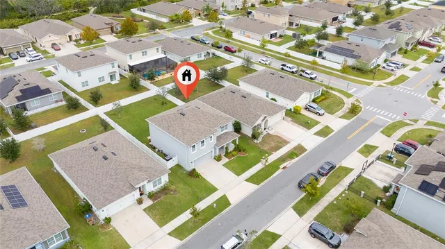 an aerial view of a house with a swimming pool