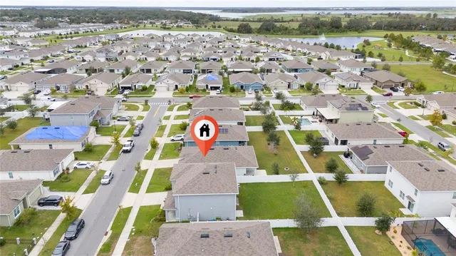 an aerial view of residential houses with outdoor space