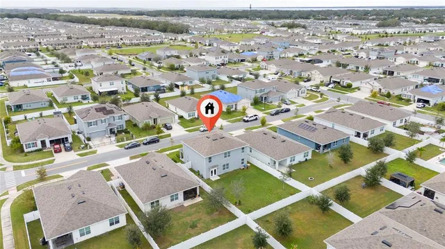 an aerial view of residential houses with outdoor space