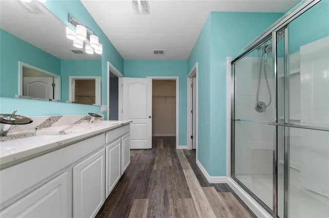 a bathroom with a double vanity sink and mirror