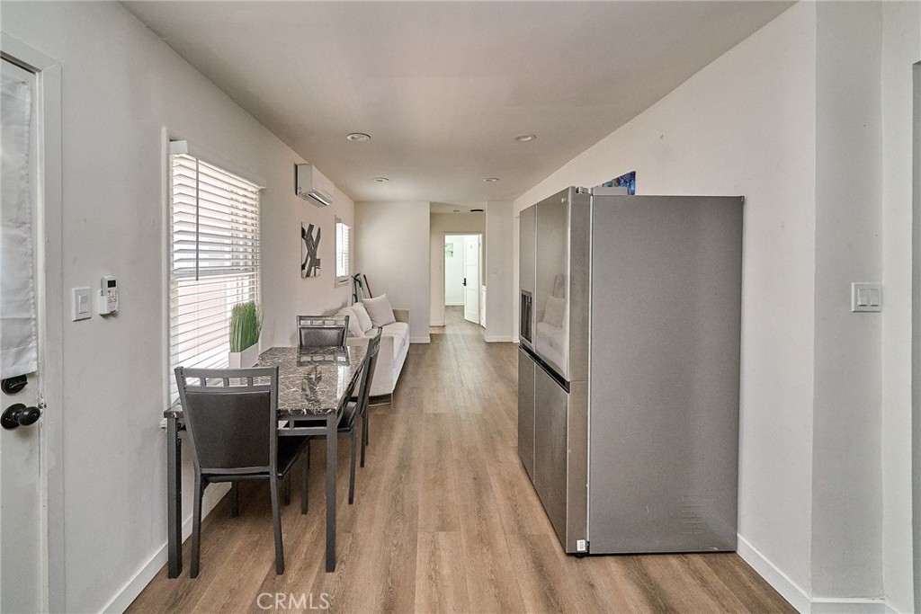 8734 Ramsgate Avenue Los Angeles, CA 90045 - Photo 11 of 19 a dining room with furniture and wooden floor