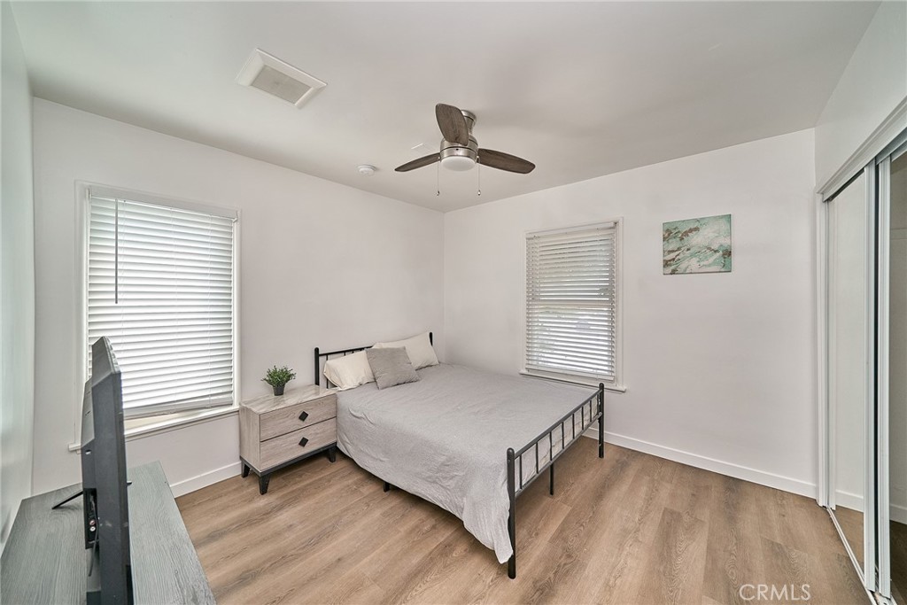 8734 Ramsgate Avenue Los Angeles, CA 90045 - Photo 12 of 19 a bedroom with a bed and a ceiling fan