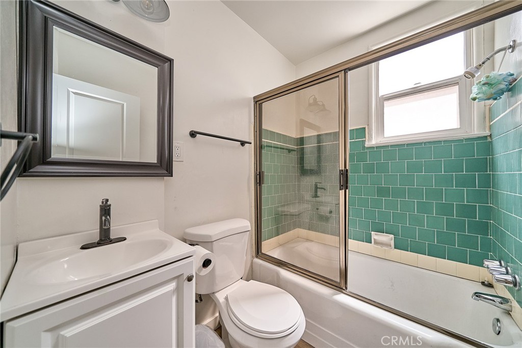 8734 Ramsgate Avenue Los Angeles, CA 90045 - Photo 13 of 19 a bathroom with a toilet sink vanity tub and mirror