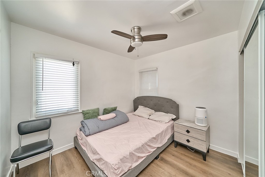 8734 Ramsgate Avenue Los Angeles, CA 90045 - Photo 14 of 19 a bedroom with a bed and a chair