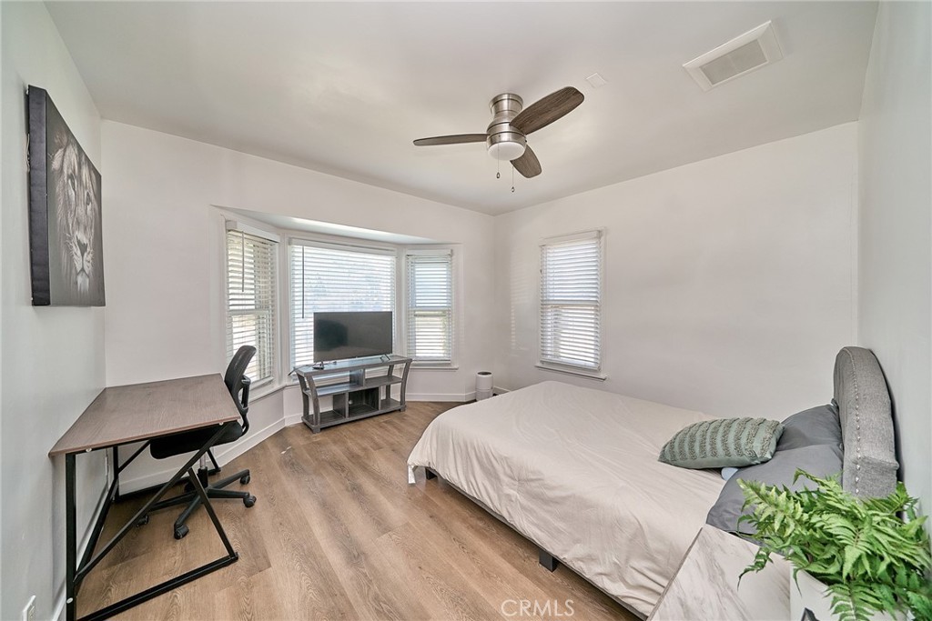 8734 Ramsgate Avenue Los Angeles, CA 90045 - Photo 18 of 19 a bedroom with a bed window and a table