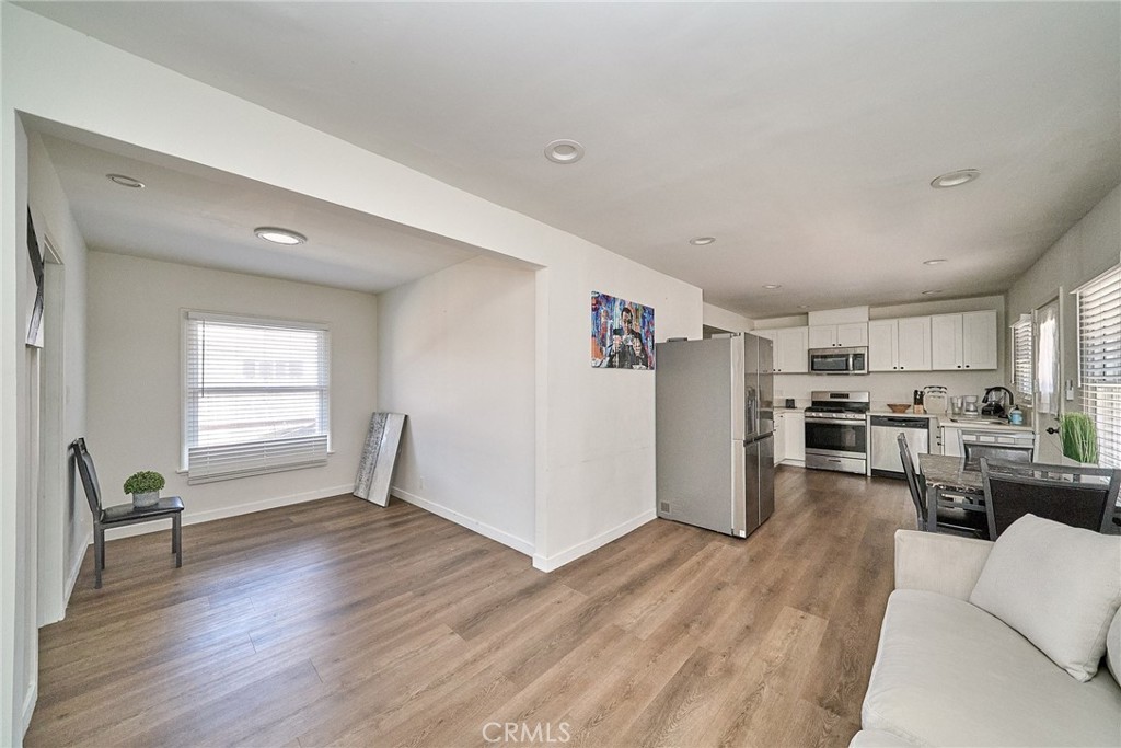 8734 Ramsgate Avenue Los Angeles, CA 90045 - Photo 9 of 19 a view of a living room hardwood floor and a kitchen