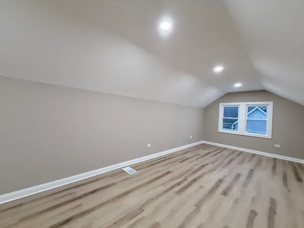 a view of room with window and hardwood floor