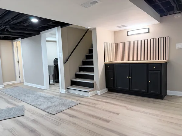 a view of a livingroom with stairs and furniture