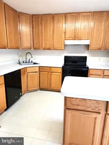 a kitchen with stainless steel appliances a refrigerator sink and cabinets