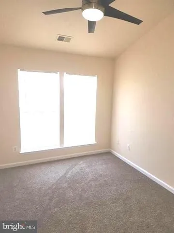 a view of a patio with table and chairs