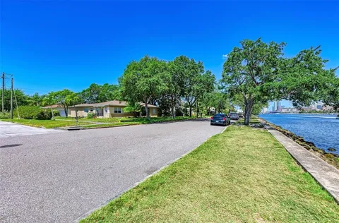 a view of a park with large trees