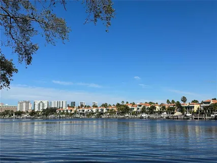 a view of a lake with boats and trees in the background