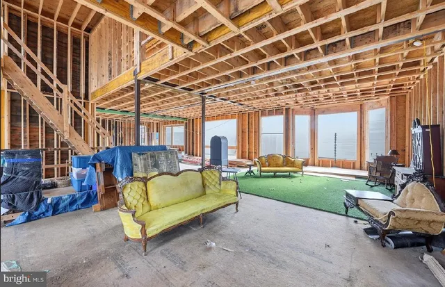 a backyard of a house with a table and chairs