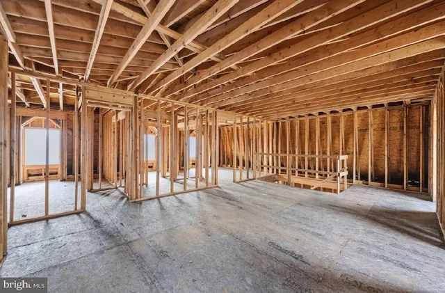 a view of an empty room with floor to ceiling window and stairs
