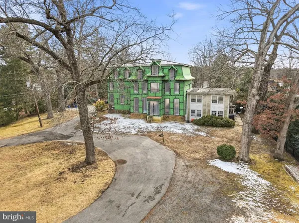 a view of a house with snow on the background