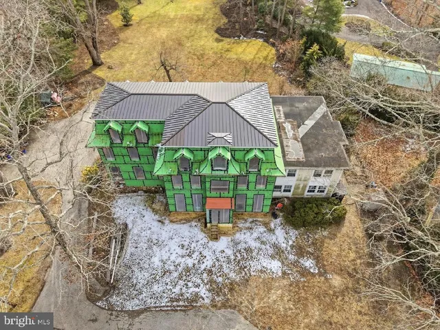 a aerial view of a house with a yard