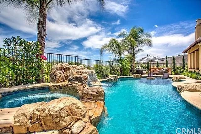 a view of a swimming pool and lounge chair