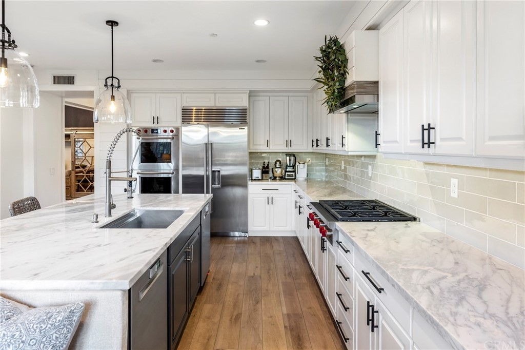 2 Emmy Lane Ladera Ranch, CA 92694 - Photo 12 of 25 a kitchen with granite countertop a sink a counter space appliances and cabinets