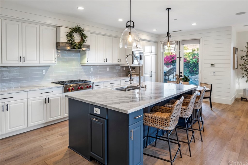 2 Emmy Lane Ladera Ranch, CA 92694 - Photo 3 of 25 a kitchen with granite countertop a table chairs stove and white cabinets