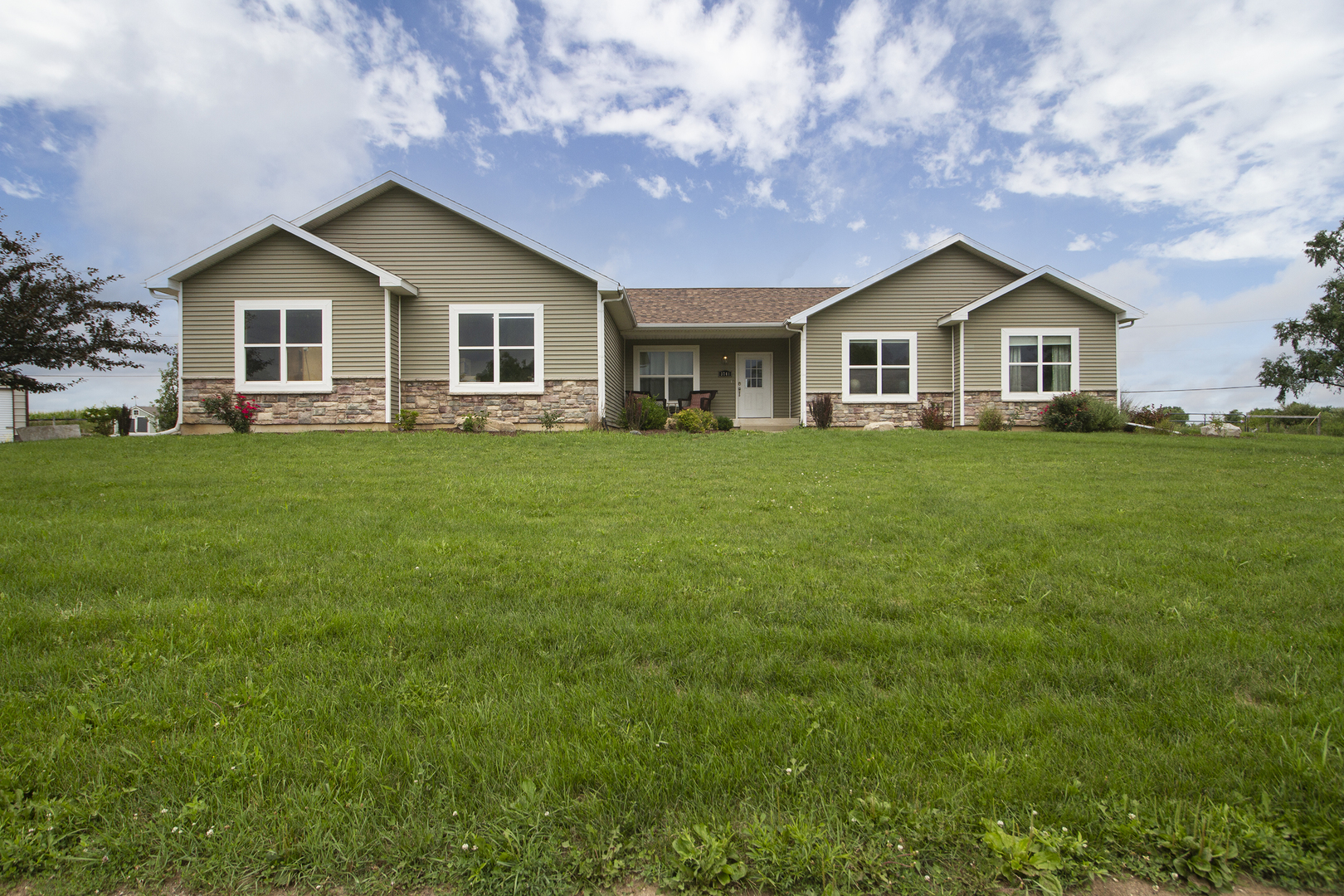 a front view of a house with yard