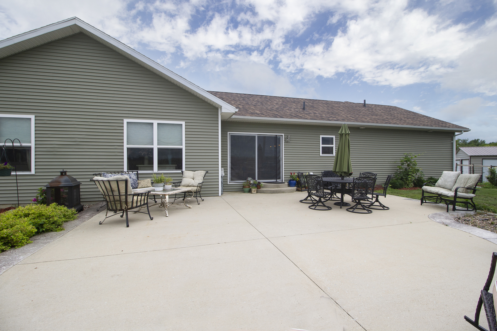 3741 East Chestnut Street Kankakee, IL 60901 - Photo 21 of 44 a view of backyard with a table and chairs and potted plants