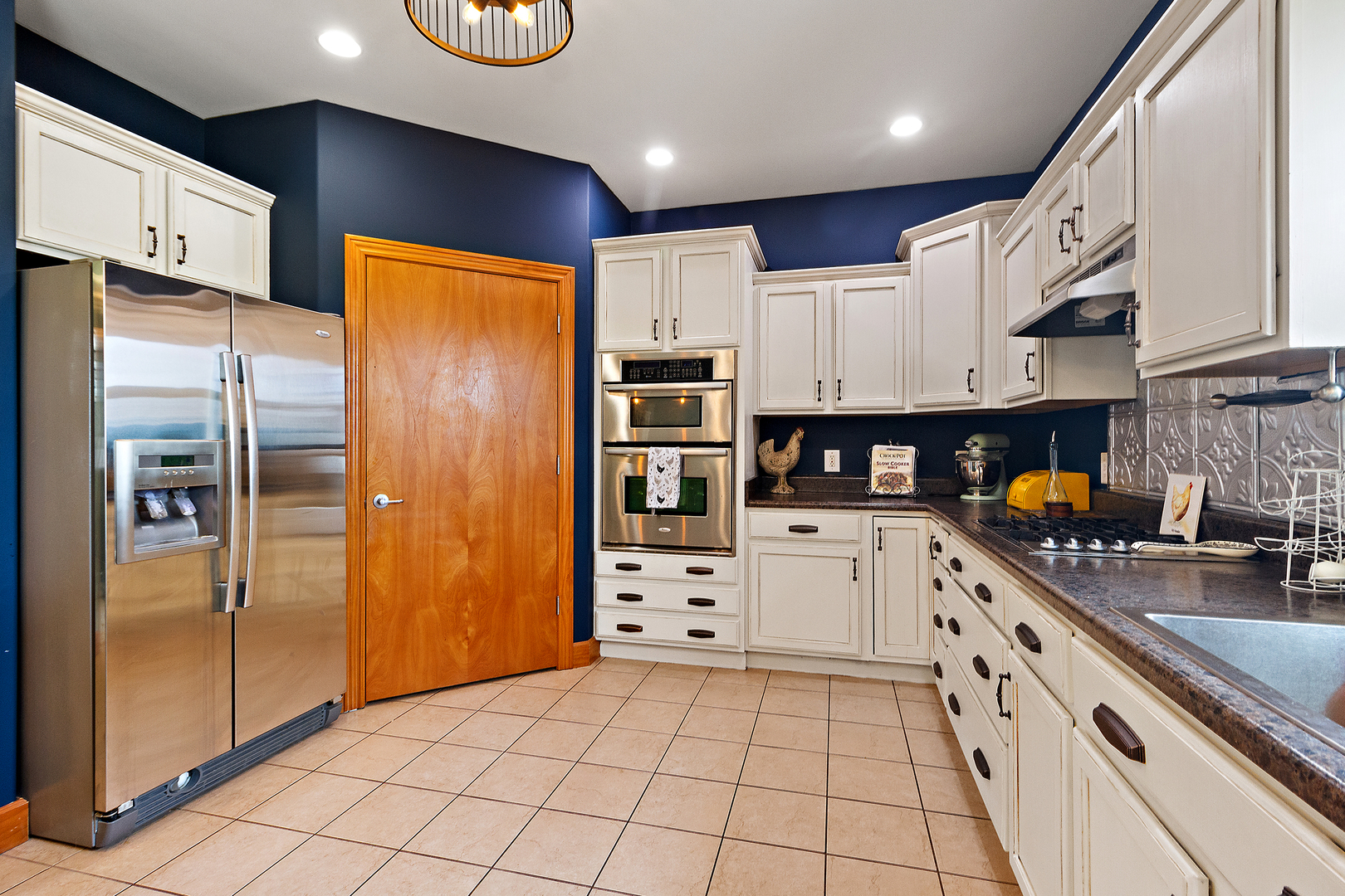 3741 East Chestnut Street Kankakee, IL 60901 - Photo 6 of 44 a kitchen with stainless steel appliances a refrigerator sink and cabinets