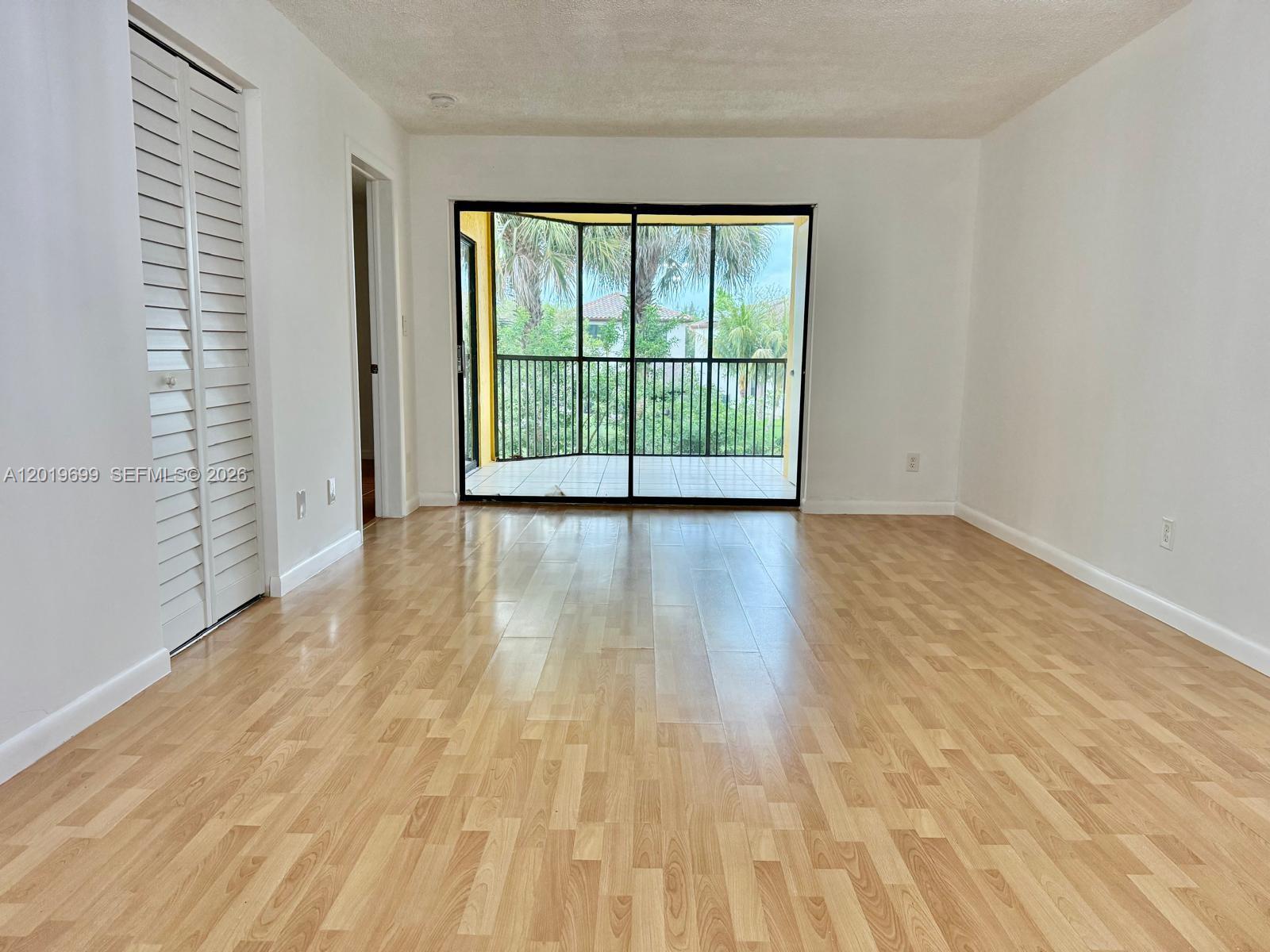 3470 Foxcroft Road, Unit 204 Miramar, FL 33025 - Photo 6 of 40 wooden floor in an empty room with a window