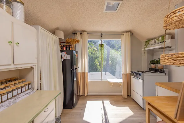 a kitchen with a refrigerator a stove and a sink