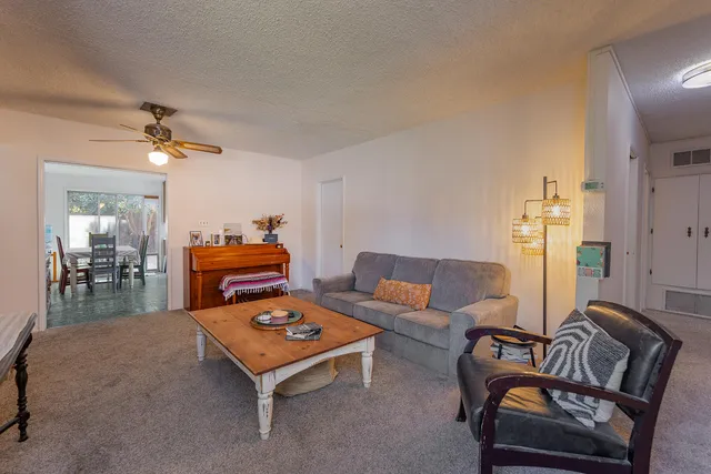 a living room with furniture and a chandelier