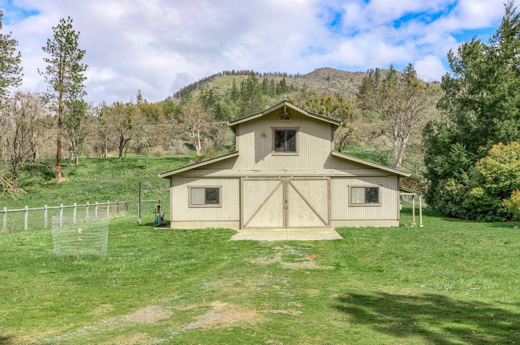 2076 Upper Applegate Road Jacksonville, OR 97530 - Photo 6 of 35 a white house with a small yard and big trees