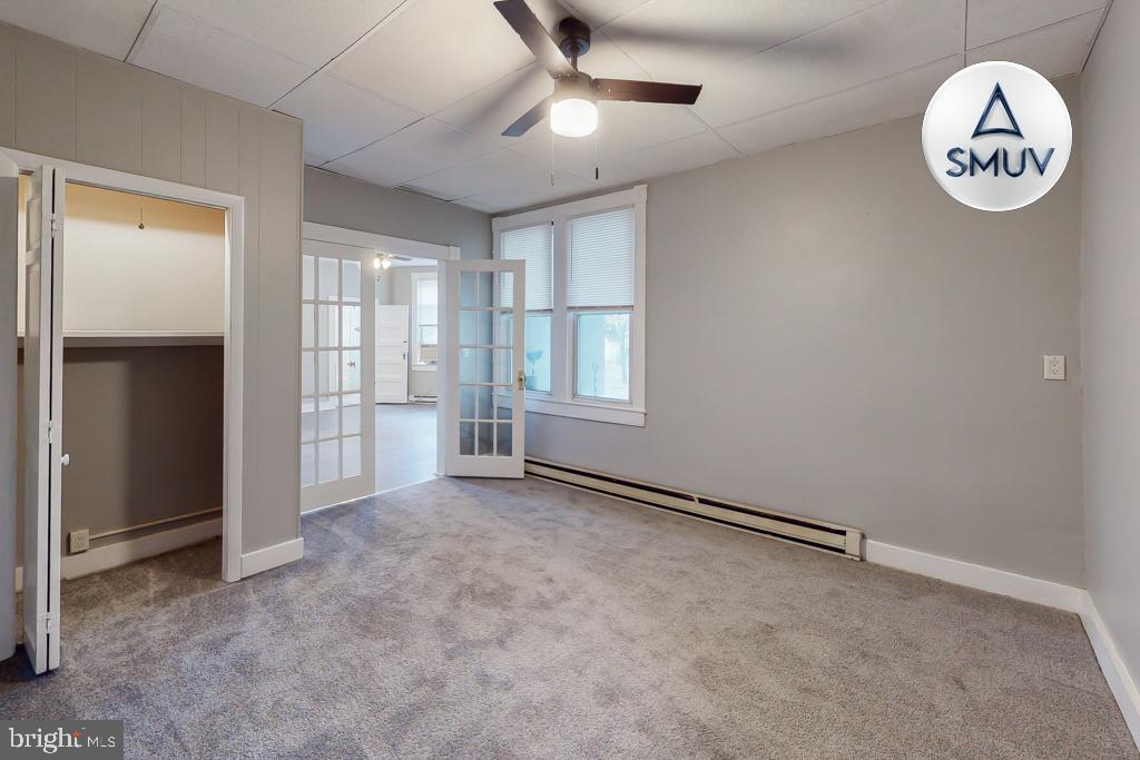 14 East Overlea Avenue, Unit 1 Baltimore, MD 21206 - Photo 11 of 15 an empty room with windows and closet