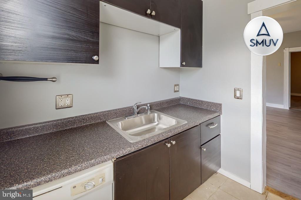 14 East Overlea Avenue, Unit 1 Baltimore, MD 21206 - Photo 14 of 15 a kitchen with a sink and a refrigerator