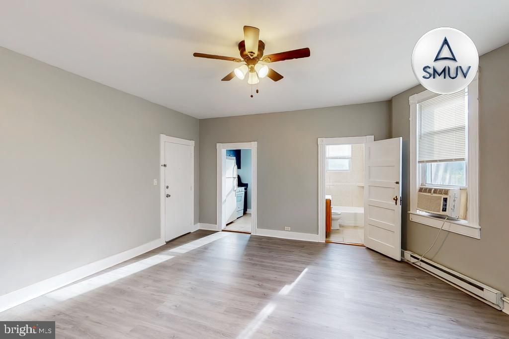 14 East Overlea Avenue, Unit 1 Baltimore, MD 21206 - Photo 2 of 15 wooden floor in an empty room with a window