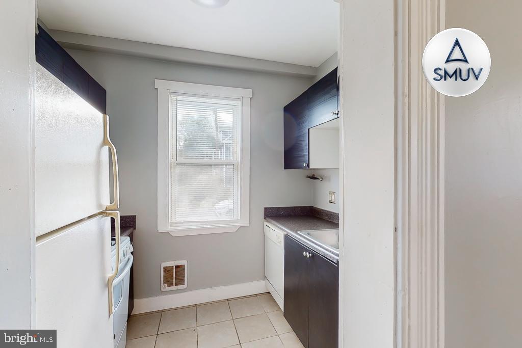 14 East Overlea Avenue, Unit 1 Baltimore, MD 21206 - Photo 4 of 15 a view of kitchen with washer and dryer