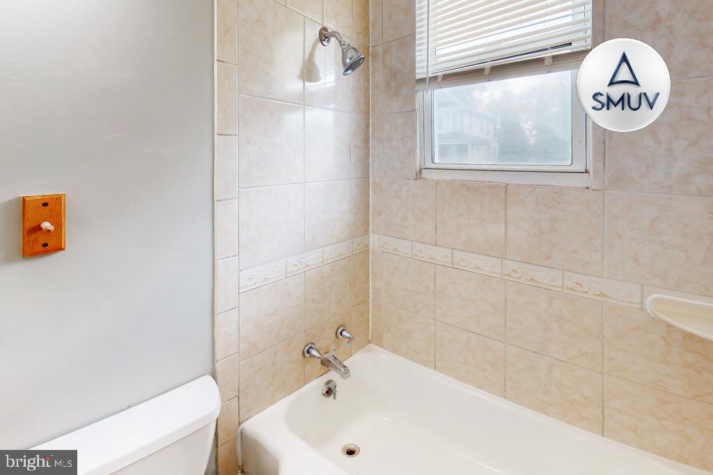 14 East Overlea Avenue, Unit 1 Baltimore, MD 21206 - Photo 10 of 15 a bathroom with a bathtub and a shower