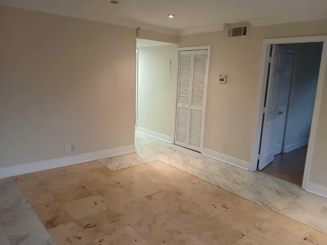 an empty room with closet area