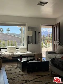 a living room with furniture and a rug