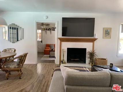 a bedroom with two beds and a potted plant
