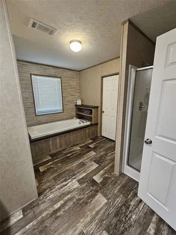 a bedroom with a bed and a refrigerator