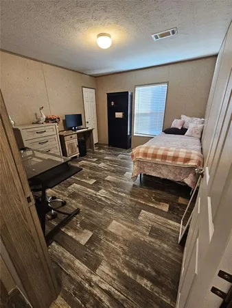 a bedroom with a bed and a dresser