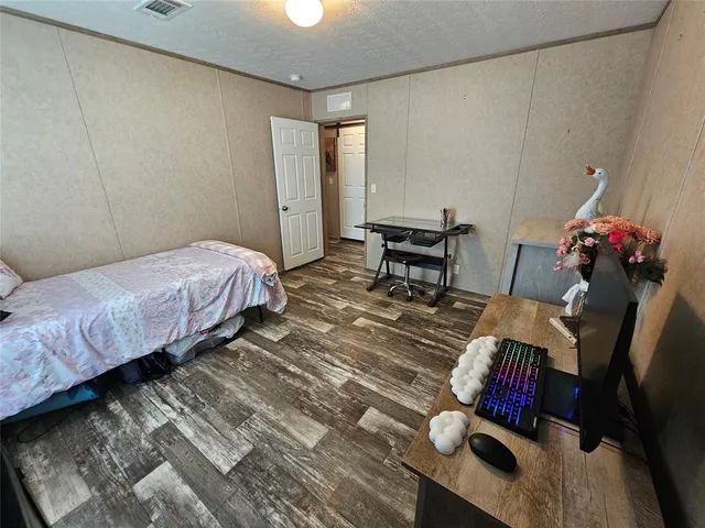 a bed room with a bed and a chair