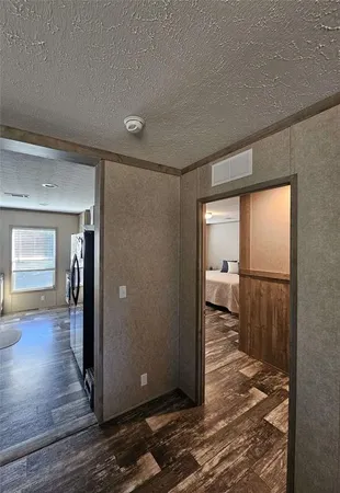 a view of a room with wooden floor and a bathroom