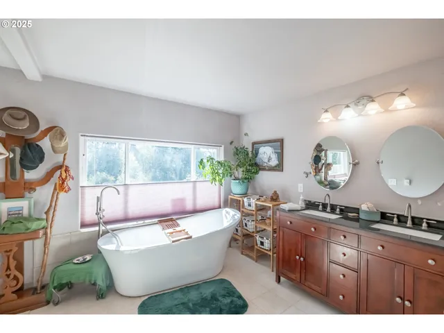 a living room with furniture a mirror and a window