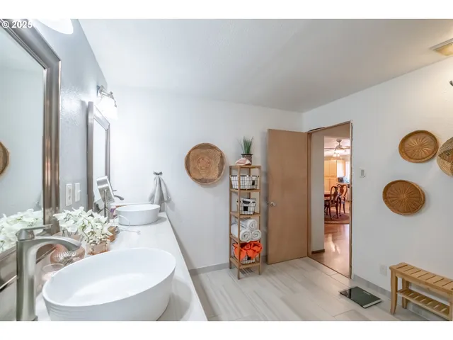 a bathroom with a sink a mirror and a shower