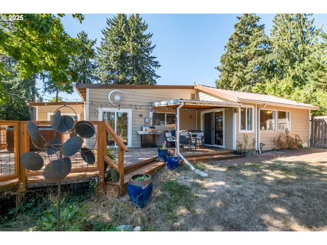 a view of a house with backyard sitting area and garden