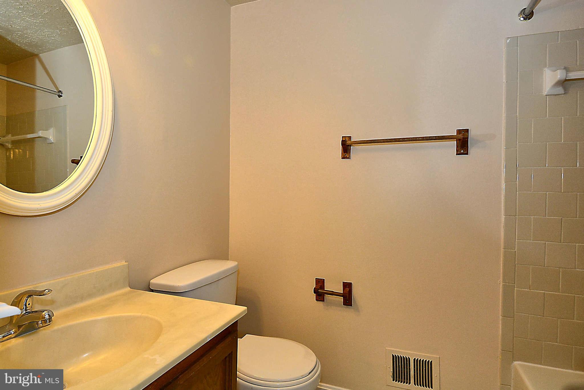 11457 Encore Drive Silver Spring, MD 20901 - Photo 13 of 27 a bathroom with a sink mirror and toilet