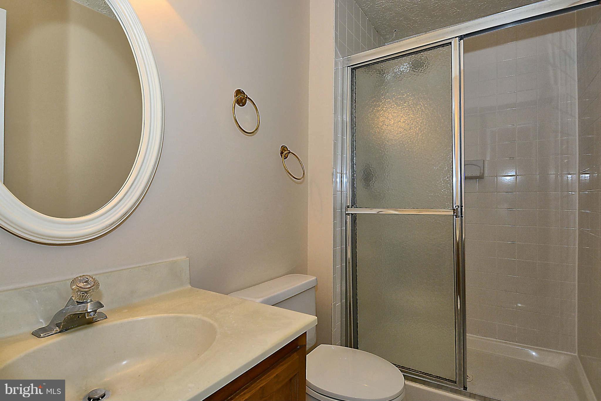 11457 Encore Drive Silver Spring, MD 20901 - Photo 16 of 27 a bathroom with a sink toilet and shower